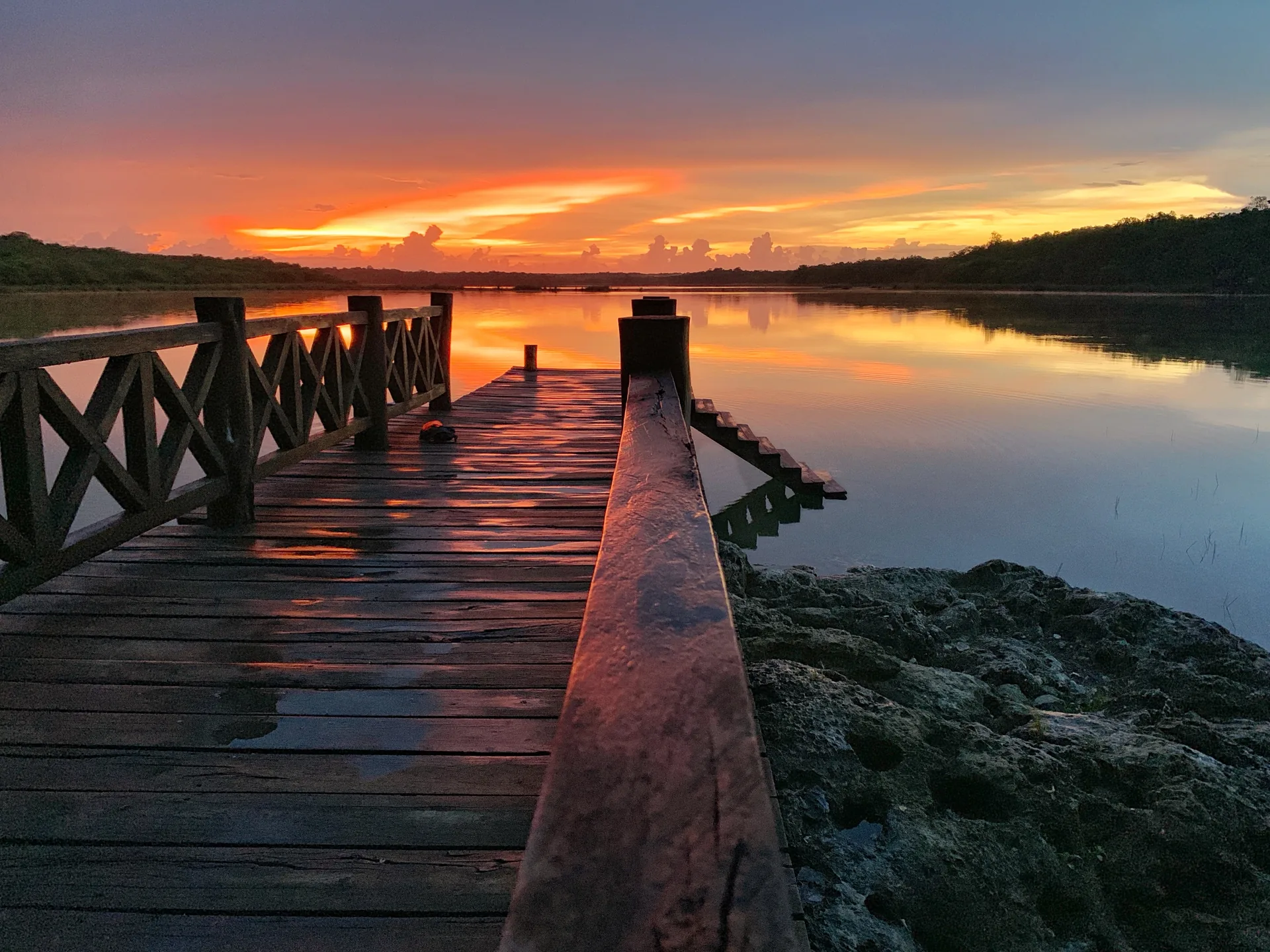 Sunset over the lagoon and pier at Punta Laguna