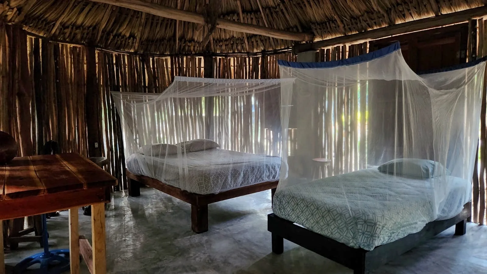 Beds with mosquito nets inside the LOL-CHE’ Double Cabin