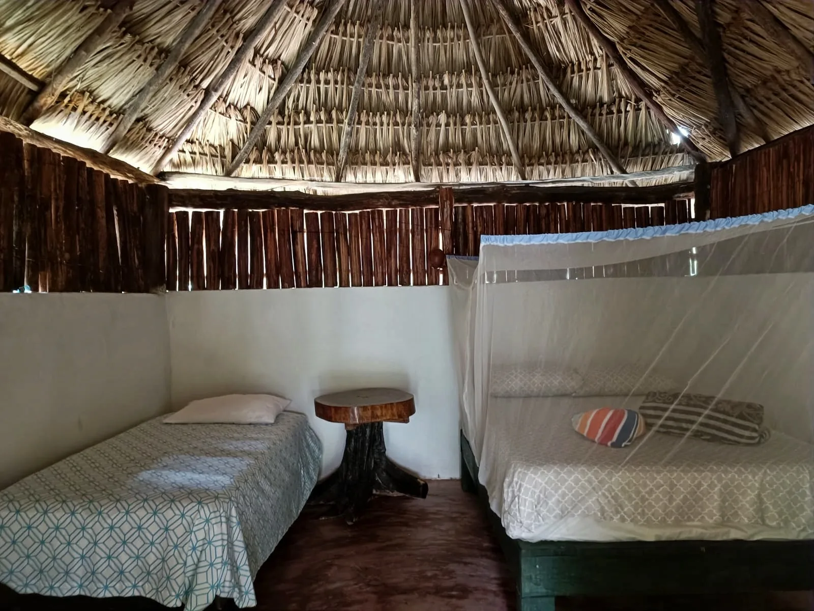 Beds and mosquito nets inside the LOL-CHE’ Single Cabin